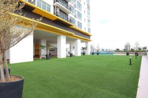 a large artificial lawn in front of a building at Novo 8 Residence Bachang By Heystay Management in Kampong Tambak