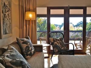 a living room with a couch and a balcony at Furmston House & Studio in Healesville