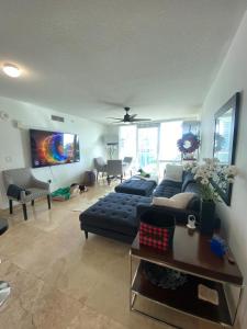 a living room with a couch and a tv at Comfortable room in the Brickell City Center area in Miami