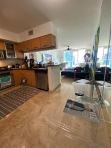 a kitchen and living room with a glass table at Comfortable room in the Brickell City Center area in Miami