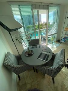 a table and chairs in a room with a balcony at Comfortable room in the Brickell City Center area in Miami