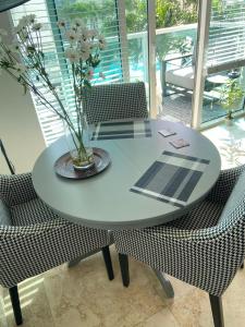 a table with a vase with flowers on it at Comfortable room in the Brickell City Center area in Miami