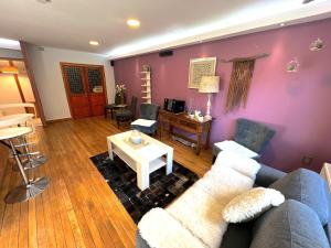a living room with a couch and a table at Incredible Downtown Duplex with Interior Backyard in Punta Arenas