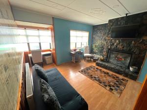a living room with a couch and a fireplace at Incredible Downtown Duplex with Interior Backyard in Punta Arenas