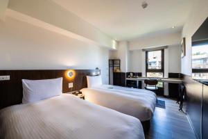 Hub Hotel - Songshan Airport Branchにあるベッド