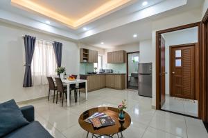 a living room with a couch and a table at AVIVA RESIDENCES in Thuan An
