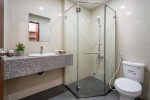 a bathroom with a shower and a toilet and a sink at AVIVA RESIDENCES in Thuan An +78 photos