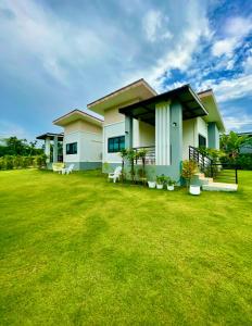 a house with a large lawn in front of it at KhaoLak Chill Out in Khao Lak