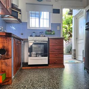 a kitchen with a stove top oven in a room at Chalet La Mambu in Mar de Ajó