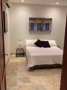 a bedroom with a bed and a picture on the wall at 212 Cartagena Walled City Magical Apt in Cartagena de Indias