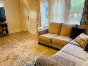 a living room with a couch and a television at Modern Farmhouse on Kent Street in Saint Paul