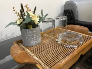 a table with a vase with flowers on it at Sunny A Hotel in Hue +79 photos