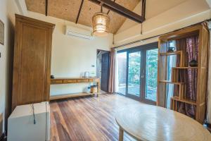 a dining room with a table and some windows at Yi's Garden Villa in Chiang Mai