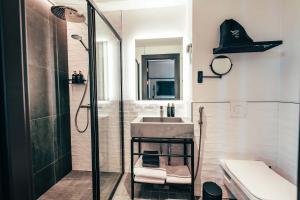 a bathroom with a shower and a sink at Clarion Hotel Mestari in Helsinki