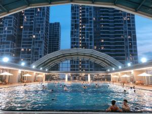 a swimming pool in a city at night at Apartment 1BR-FL22th-R103 Building-Vinhome Ocean Park in Hanoi