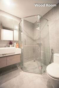 a bathroom with a shower and a toilet and a sink at Apartment 1BR-FL22th-R103 Building-Vinhome Ocean Park in Hanoi