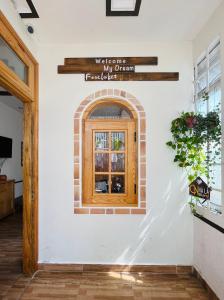 un muro con una finestra e un cartello sopra di My Dream Hotel a Da Lat