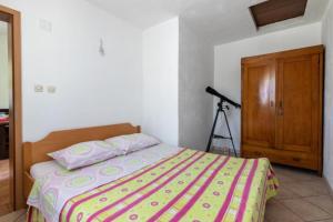 a bedroom with a bed and a camera at Holiday home Branko - large terrace in Postira
