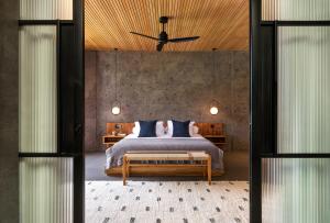 a bedroom with a large bed with a wooden ceiling at Villa Oasis Bali in Dalung +47 photos