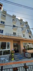 a large white building with a table in front of it at BB Hotel&Resort in Phu Quoc +79 photos