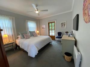 a bedroom with a bed and a ceiling fan at Explorers Lodge in New Norfolk