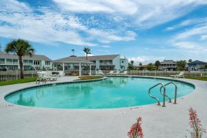 a large swimming pool in a yard with houses at Coastal Bliss in Rockport