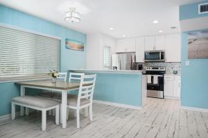 a kitchen with blue walls and a table and chairs at Coastal Bliss in Rockport