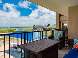 a balcony with a table and a view of the ocean at LR 210 - Mustang Isle in Rockport