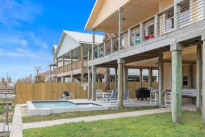 a house with a deck and a swimming pool at The Cats Meow in Rockport