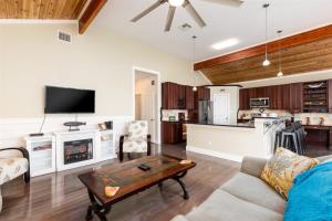 a living room with a couch and a table at The Cats Meow in Rockport +30 photos