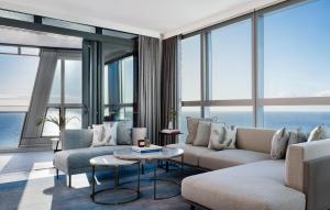 a living room with a couch and a table at The Langham, Gold Coast and Jewel Residences in Gold Coast