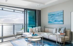 a living room with a couch and tables at The Langham, Gold Coast and Jewel Residences in Gold Coast