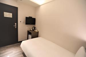 Postel nebo postele na pokoji v ubytování Chair Man Hotel