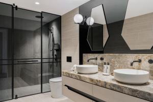 a bathroom with two sinks and a shower at The Langham, Gold Coast and Jewel Residences in Gold Coast