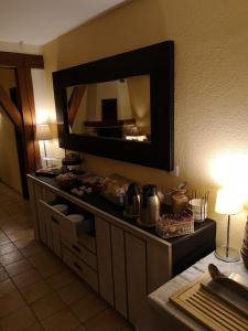 a kitchen with a large mirror on the wall at Domaine de la Borde in Damparis