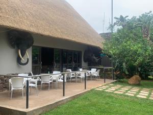 a restaurant with an elephant head and tables and chairs at Selati River Ruins in Gravelotte