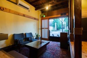 a room with chairs and a table and a window at Bamba Hotel Tokyo-Private Townhouse- in Tokyo