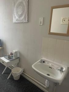 a bathroom with a sink and a toilet at Shakers Inn in Harwich