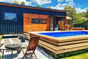 a backyard with a swimming pool and a tiny house at Alley Tiny House in Fethiye