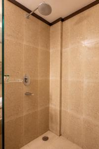 a bathroom with a shower with a glass door at Revathi Resorts in Jajal