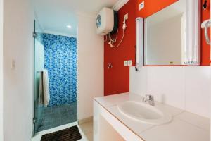 a bathroom with a sink and a shower at RedDoorz at Kawaii Apartment Jimbaran in Balian +21 photos