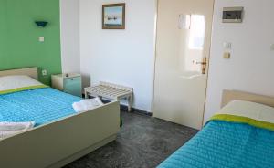 Ένα ή περισσότερα κρεβάτια σε δωμάτιο στο Mirtos Hotel