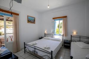 Ένα ή περισσότερα κρεβάτια σε δωμάτιο στο Rita Rooms Sifnos