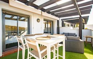 a dining room with a white table and chairs at Rock Bay I 2392 beautiful seaview penthouse in Manilva