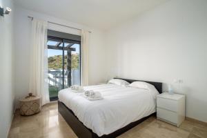 a bedroom with a large bed and a large window at Rock Bay I 2392 beautiful seaview penthouse in Manilva