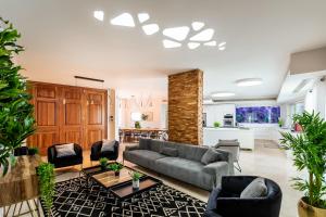 a living room with a couch and chairs at Yalarent Enorma complex with shared heated pool in Eilat
