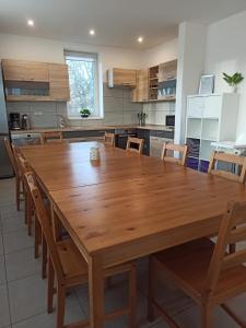 Holiday House Adrelot في Heřmaničky: مطبخ مع طاولة وكراسي خشبية كبيرة