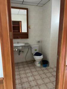 a bathroom with a toilet and a sink and a mirror at Vice City guest house in Patong Beach