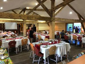 a dining room with tables and chairs with people in it at Le Relais Nordique in Giron