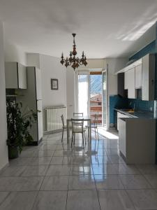 a kitchen and dining room with a table and chairs at La Casa Del Quirino in Tirano
